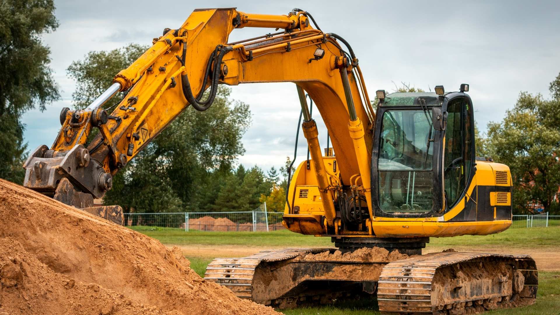 Excavator moving earth on construction site
