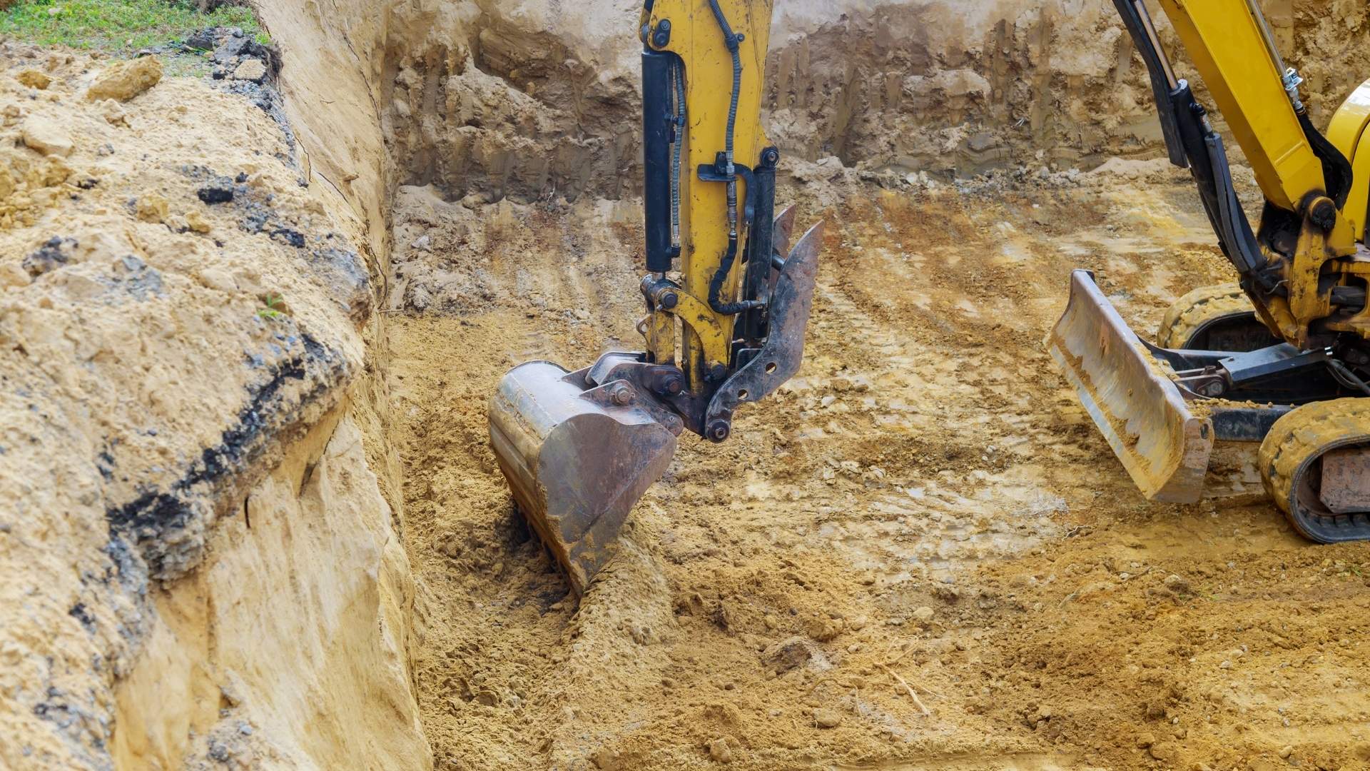 Excavator trenching for drainage installation